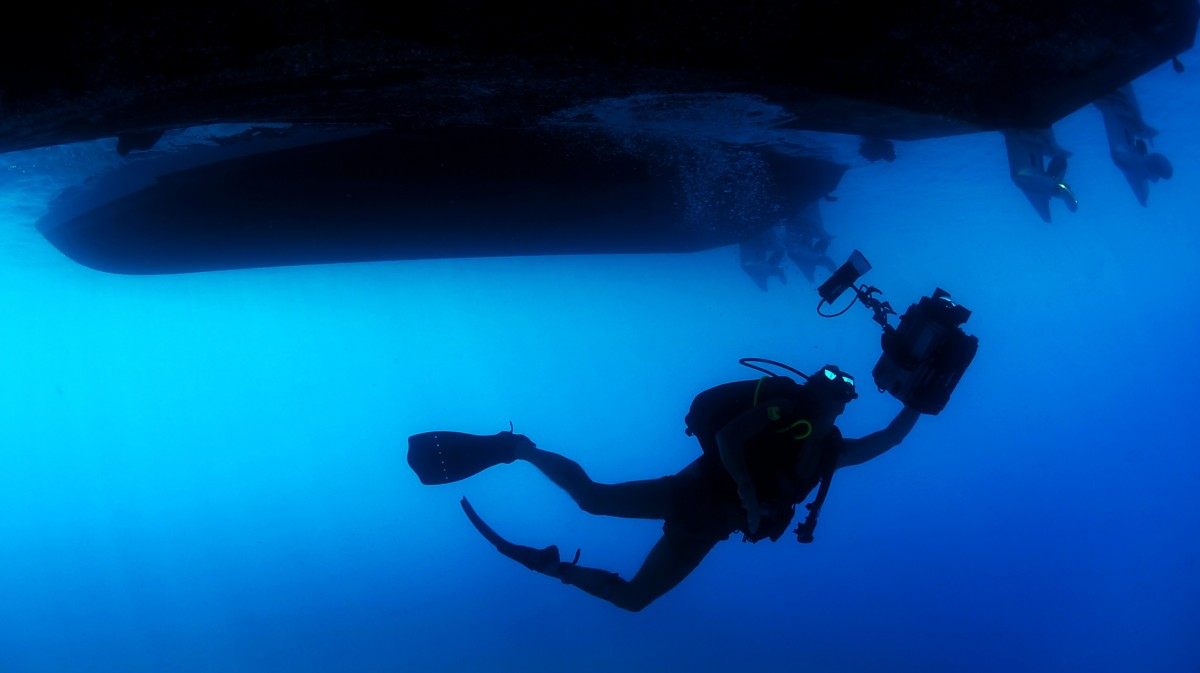 scuba diver in deep blue sea